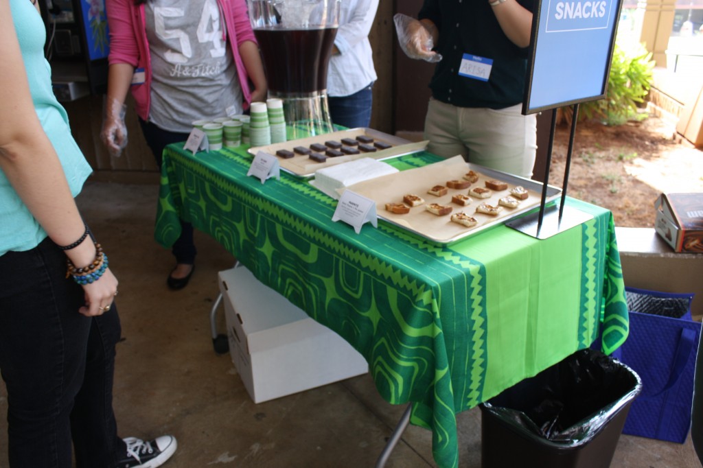 Student sampling free desserts at the library entrance