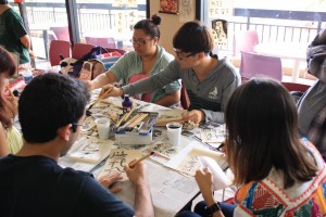 KCC Chinese language students utilizing the calligraphy sets at the Chinese table.