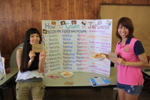 Japanese booth, run by exchange students (L to R) Yuka Miyoshi and Chihiro Matsukawa, teaching students how to count items in Japanese.