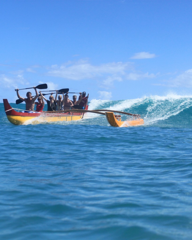 Tourists enjoy the Hawaiian sport of outrigger surfing