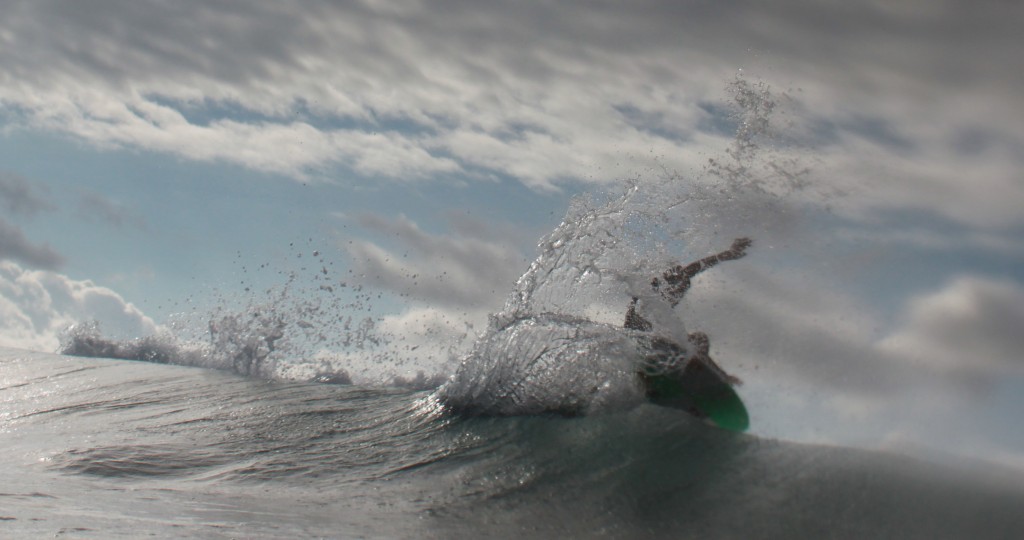 A young surfer hovers above the lip at Haleiwa on the North Shore of Oahu