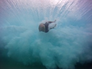 Keith Gutierez gets sucked over the falls by his board in breaking light on the east side of Oahu