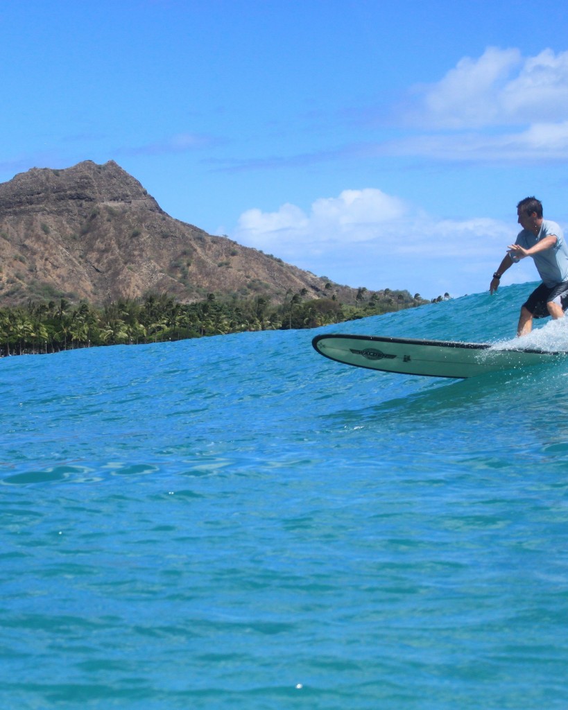 A surfer takes it all in at the foot of Diamond Head