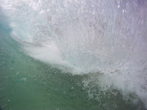 A clear wall of water covers me up during a south swell that hit sandy beach park.