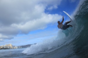 A surfer does the ultimate turn off the lip at the ultimate south shore location, Ala Moana Bowls.  Enjoy the upcoming swells over Independence weekend!