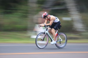 A bicyclist speeds through Haleiwa during the cycling section of the Haleiwa Triathlon.  