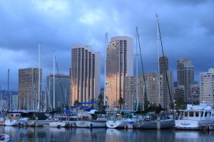 The last bits of light reflect off towers in Honolulu and the Ala Wai Harbor.