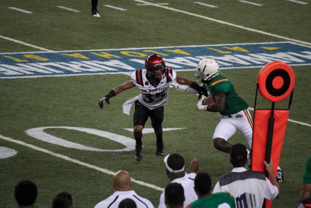 Snapped a photo of an Aztec ready to tackle a Rainbow Warrior. The game was San Diego State Aztecs vs UH Rainbow Warriors. The Warriors wore their retro uniforms that night. Photo: Devin Takahashi/Kapiʻo.