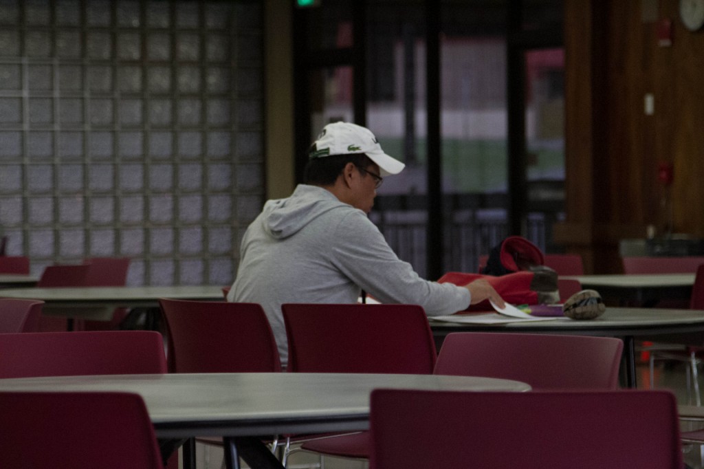A student looks focused studying in the cafeteria in the early morning. Photo: Devin Takahashi/Kapiʻo.