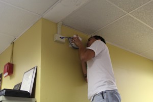 Jason Akiyama, a CELTT staff member, installed Kapio's new wireless access point today. New access points are being installed all over campus. These access points should give the campus's wireless connection a wider range. 
