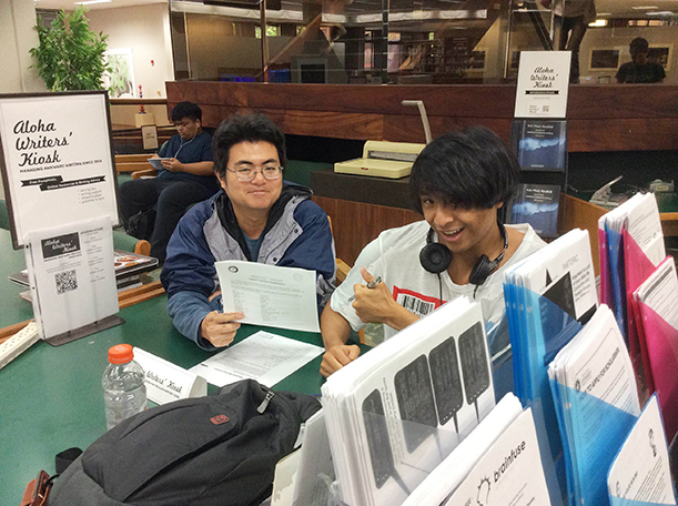 David Uedoi working with a student on his writing at the kiosk in Lama Library. Photo: Davin Kubota